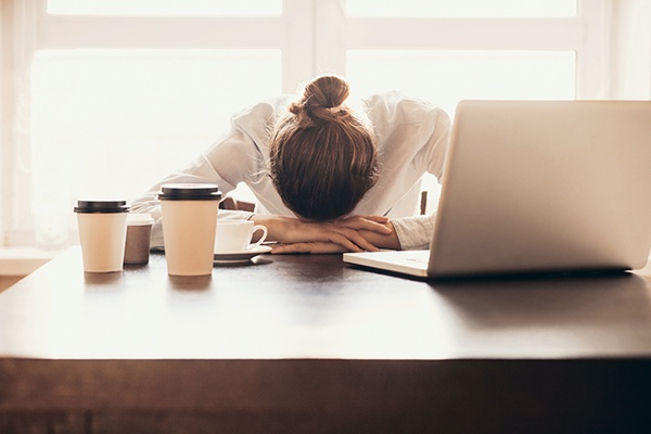 Tired employee at her desk