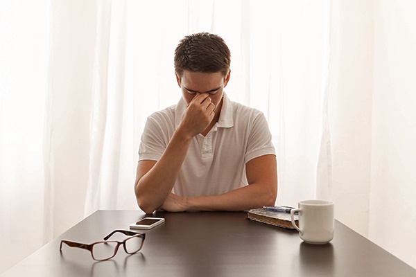 Young male struggling to stay awake